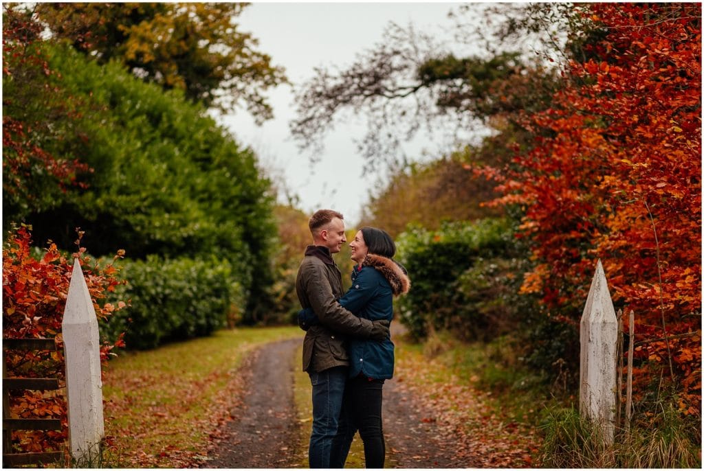 Couple in Pollok Park in Autumn standing laughing couples shoot engagement shoot