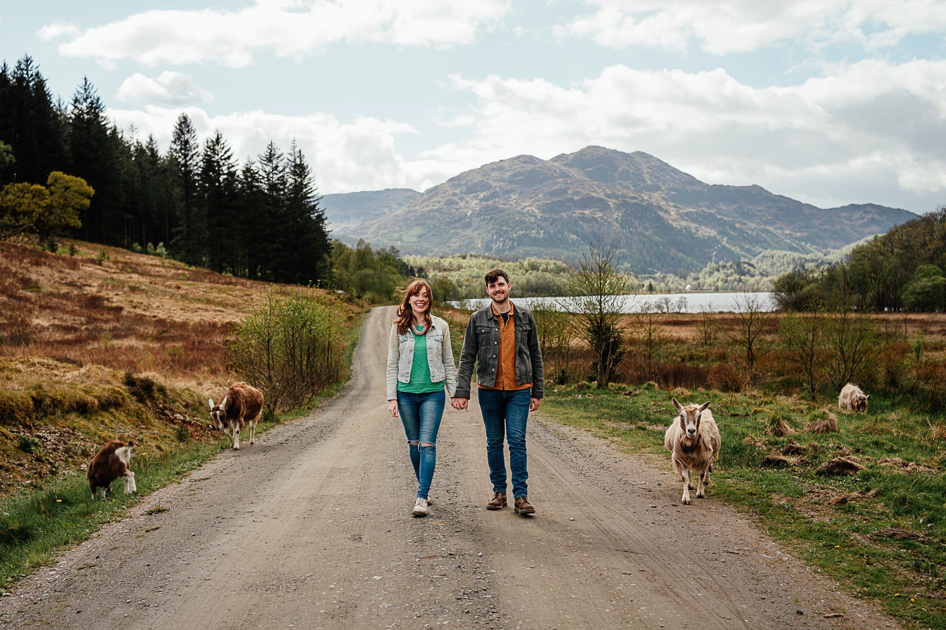 couples photos glasgow with wild goats and mountains in background behind happy couple