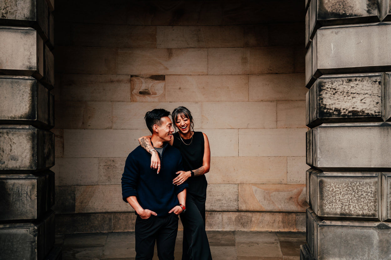 couple hug and laugh on their pre wedding photoshoot in edinburgh